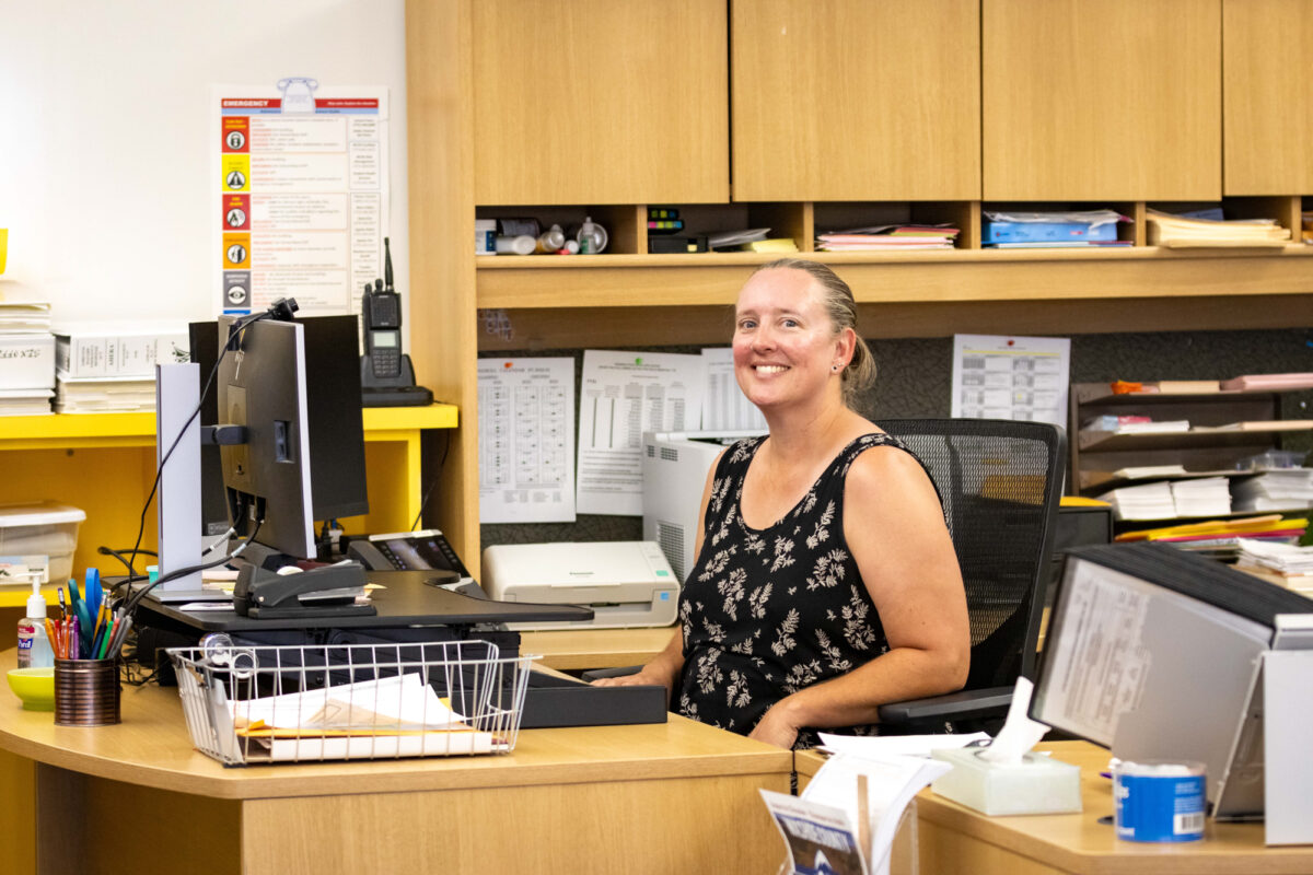 Kristy Evans poses for a portrait at her dual-purpose desk in the Gerlach Library after a ribbon-cutting ceremony in the Gerlach Library celebrating the first stage of high speed internet deployment to the rural town on Tuesday, July 25, 2023. (Tim Lenard/The Nevada Independent)